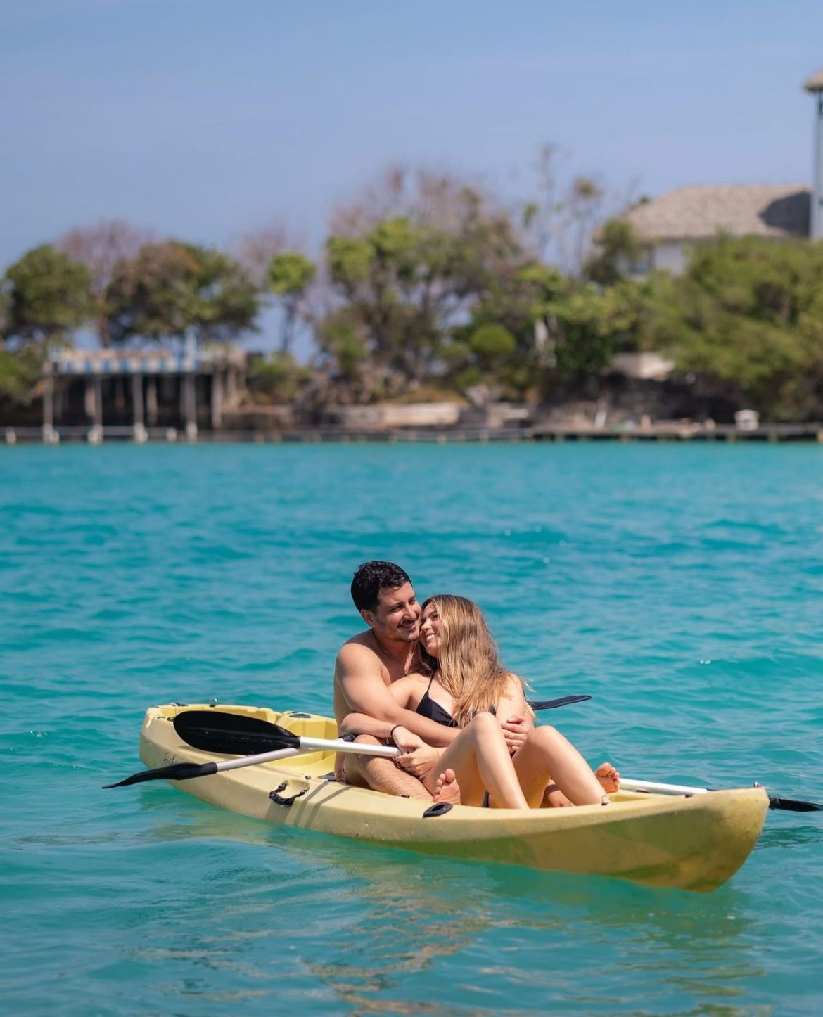 Pareja en kayak en aguas turquesa